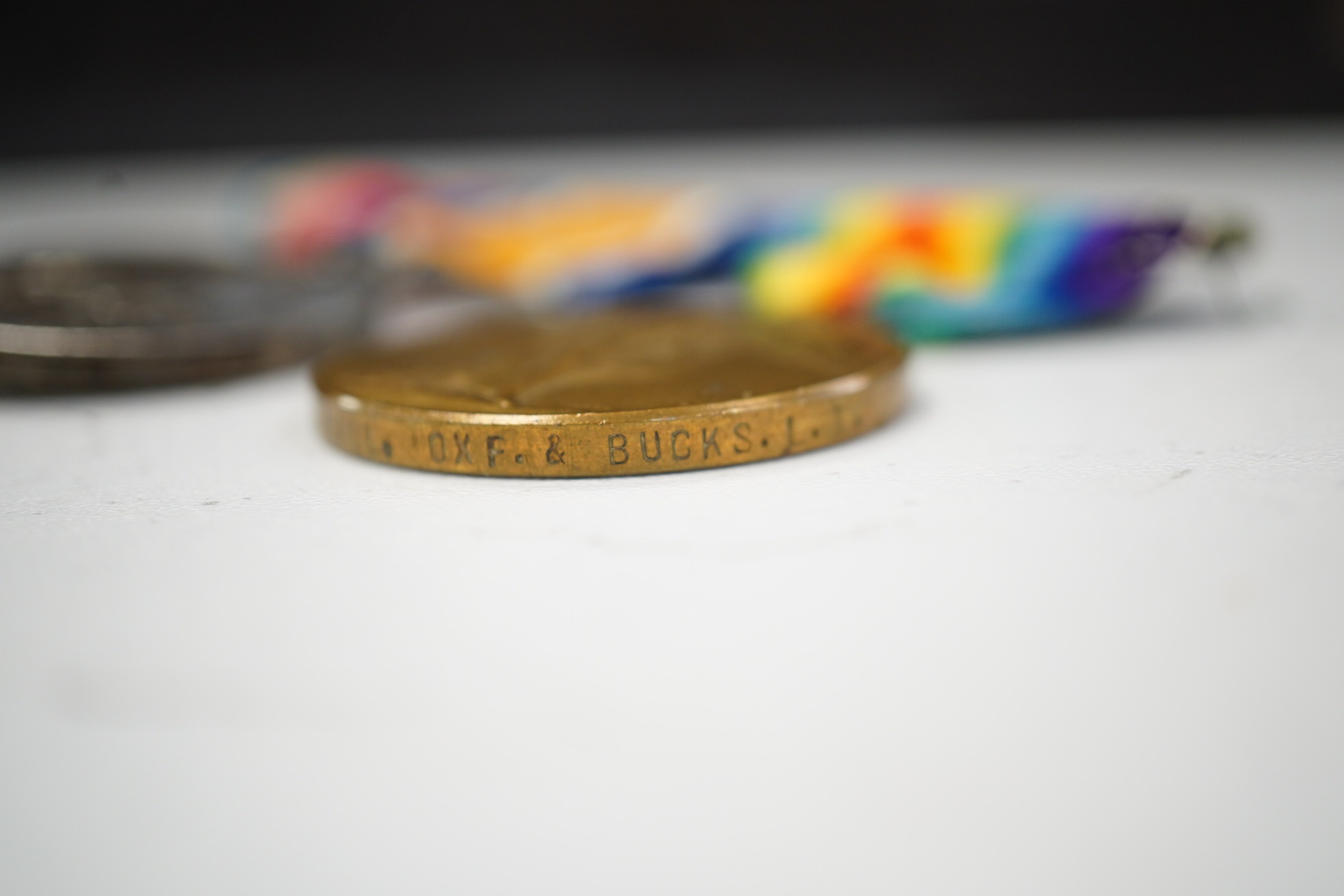 A First World War medal trio awarded to Pte. J. Ball Oxf. & Bucks. L.I., together with an oak mantle clock inset with a memorial plaque awarded to George John Ball, plus related paperwork. Condition - fair to good